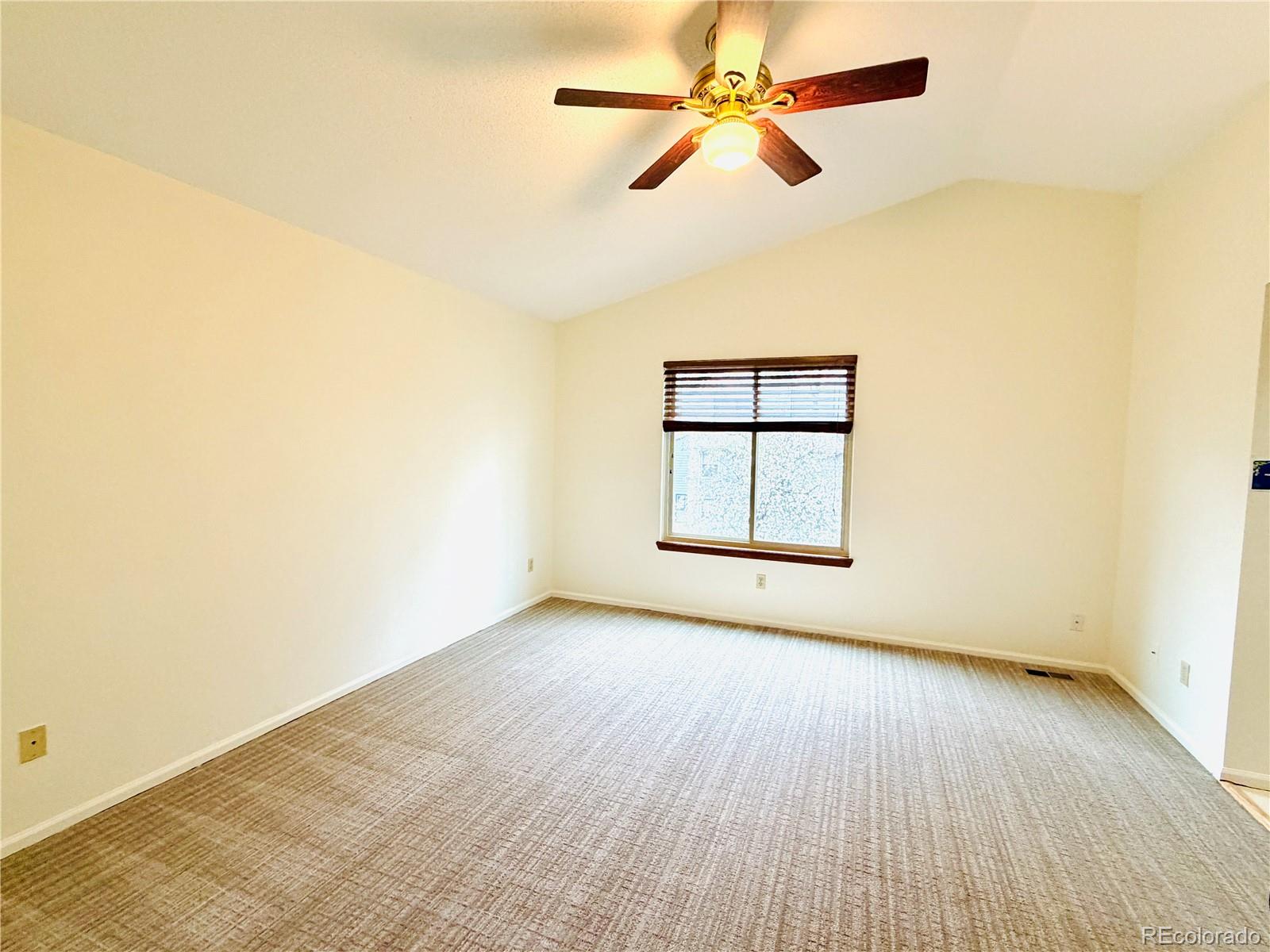 8725 Meadowlark Circle Highlands Ranch, CO 80126 - Photo 17 of 40 an empty room with wooden floor ceiling fan and windows