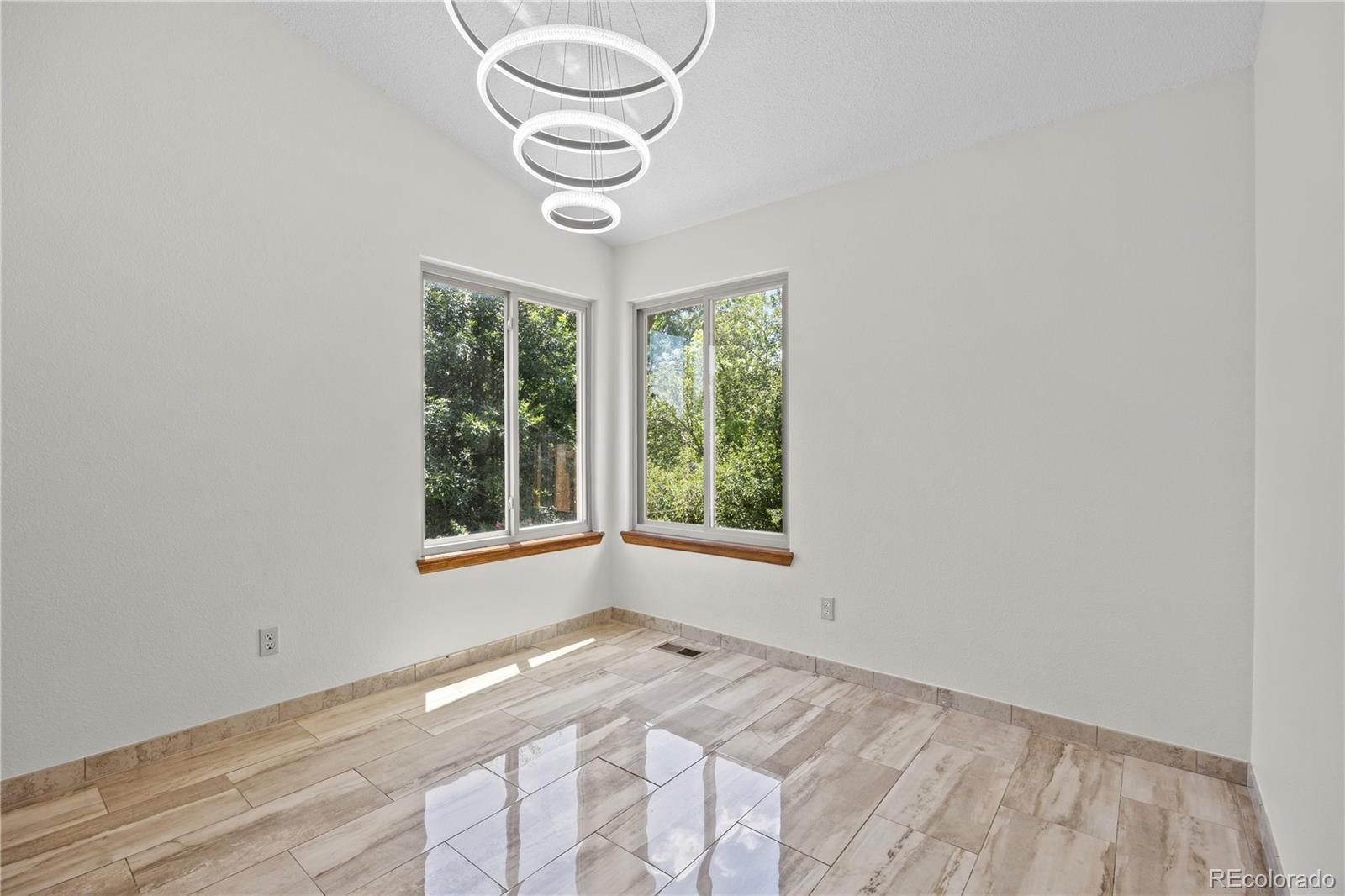8725 Meadowlark Circle Highlands Ranch, CO 80126 - Photo 2 of 40 a view of empty room with window and hardwood floor