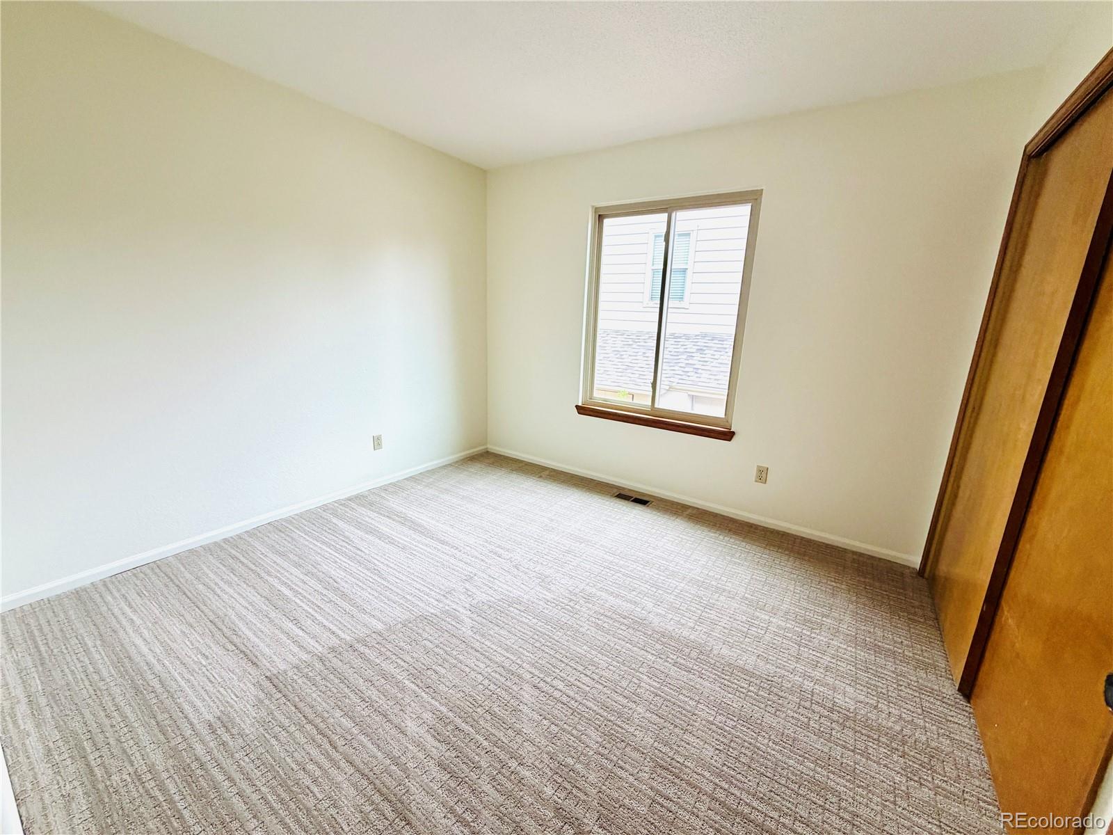8725 Meadowlark Circle Highlands Ranch, CO 80126 - Photo 21 of 40 an empty room with wooden floor and windows