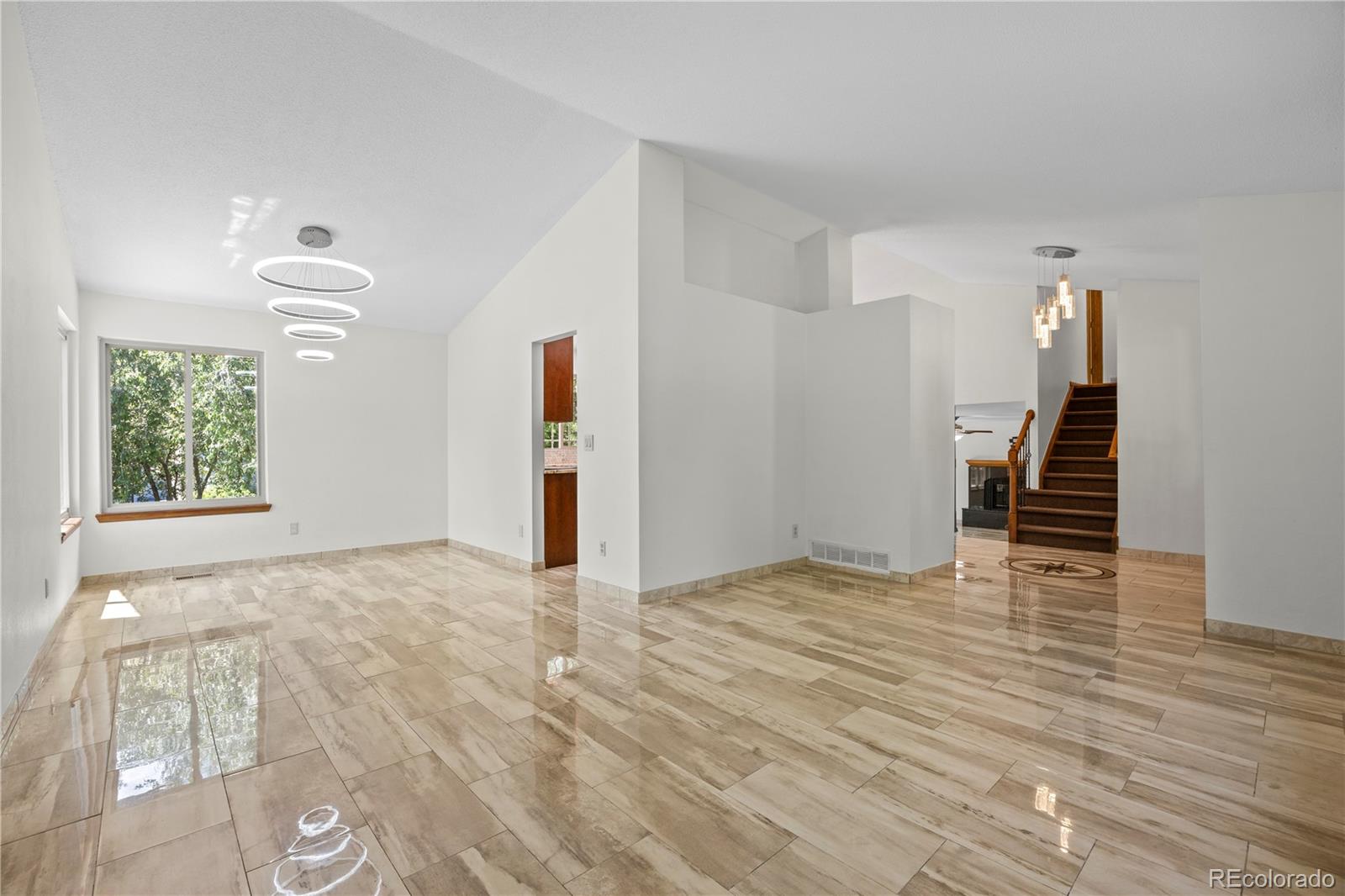 8725 Meadowlark Circle Highlands Ranch, CO 80126 - Photo 3 of 40 a view of an empty room with window and wooden floor