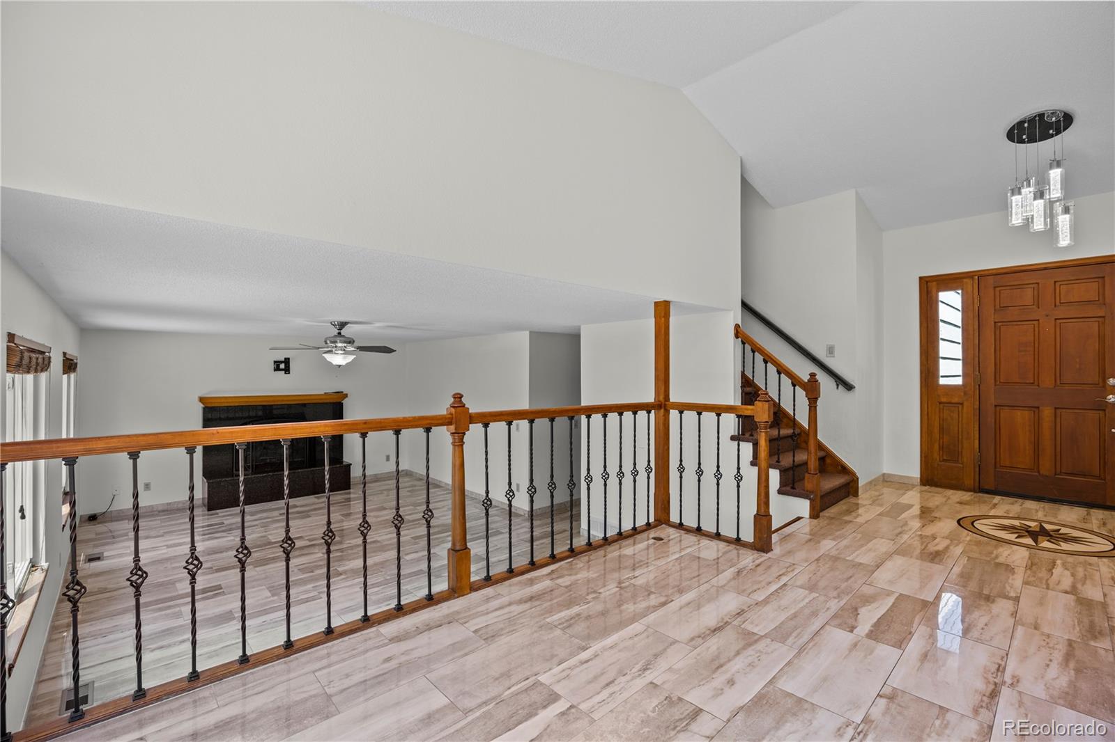 8725 Meadowlark Circle Highlands Ranch, CO 80126 - Photo 5 of 40 a view of entryway and hall with wooden floor