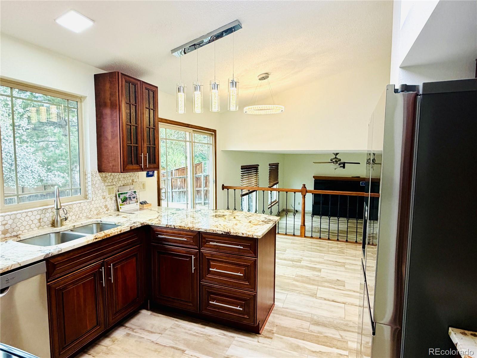 8725 Meadowlark Circle Highlands Ranch, CO 80126 - Photo 9 of 40 a kitchen with a sink and a refrigerator