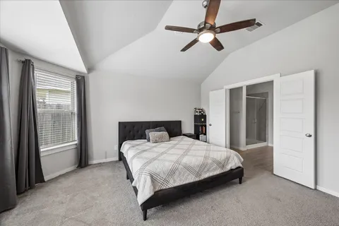a bedroom with a large bed and a large window