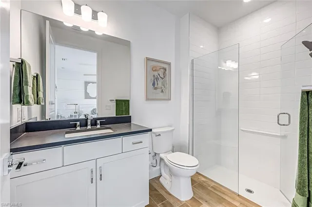 a bathroom with a toilet sink and shower