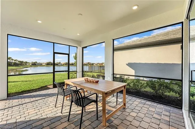 a living room with a large window and a table