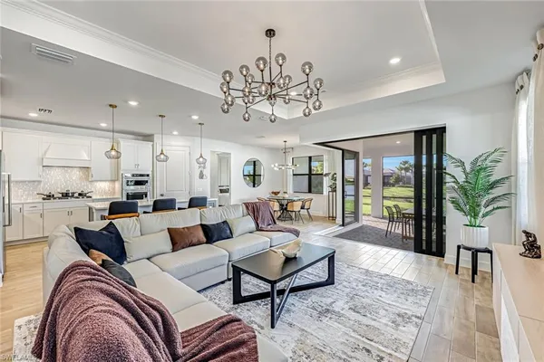 a living room with furniture and a chandelier