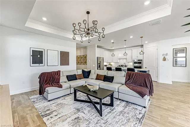 a living room with furniture or chandelier and a rug