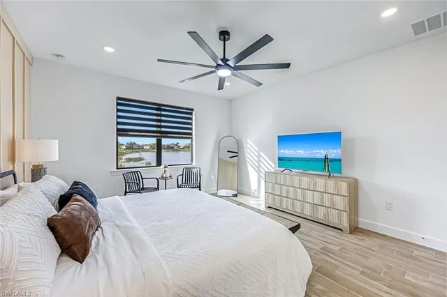 a spacious bedroom with a bed and a large window