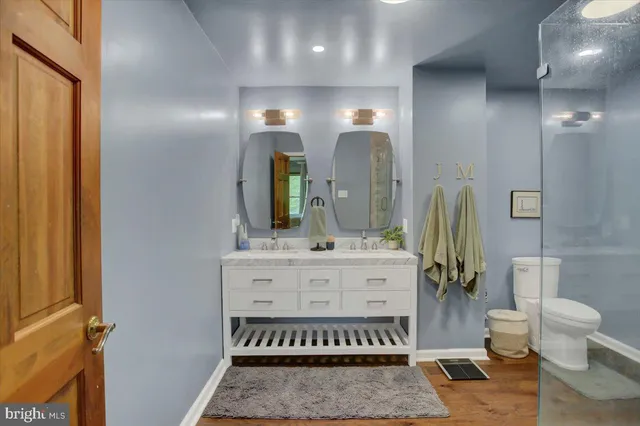 a bathroom with a double vanity sink and a mirror