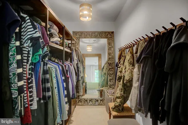 a view of walk in closet with clothes