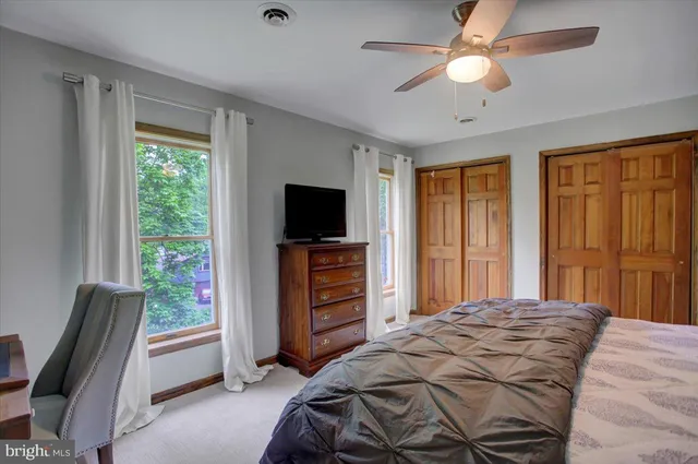 a bedroom with a bed and a television