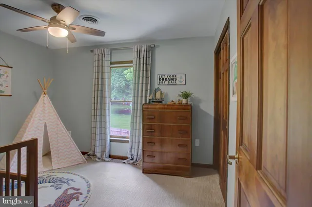a view of a livingroom with furniture and staircase