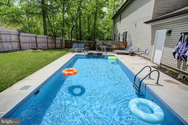 a view of a backyard with swimming pool