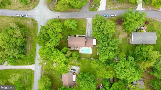 aerial view of a house with a yard and plants