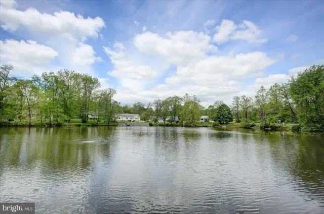 a view of a lake with houses in the background