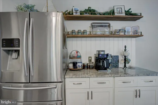 a kitchen with a refrigerator and cabinets