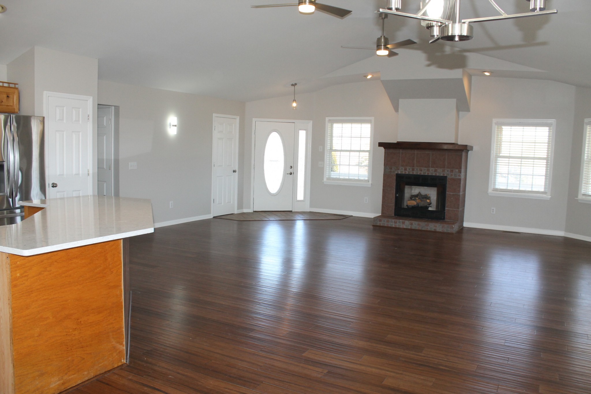 3418 Pinson School Road Springfield, TN 37172 - Photo 15 of 32 an empty room with wooden floor fireplace and windows