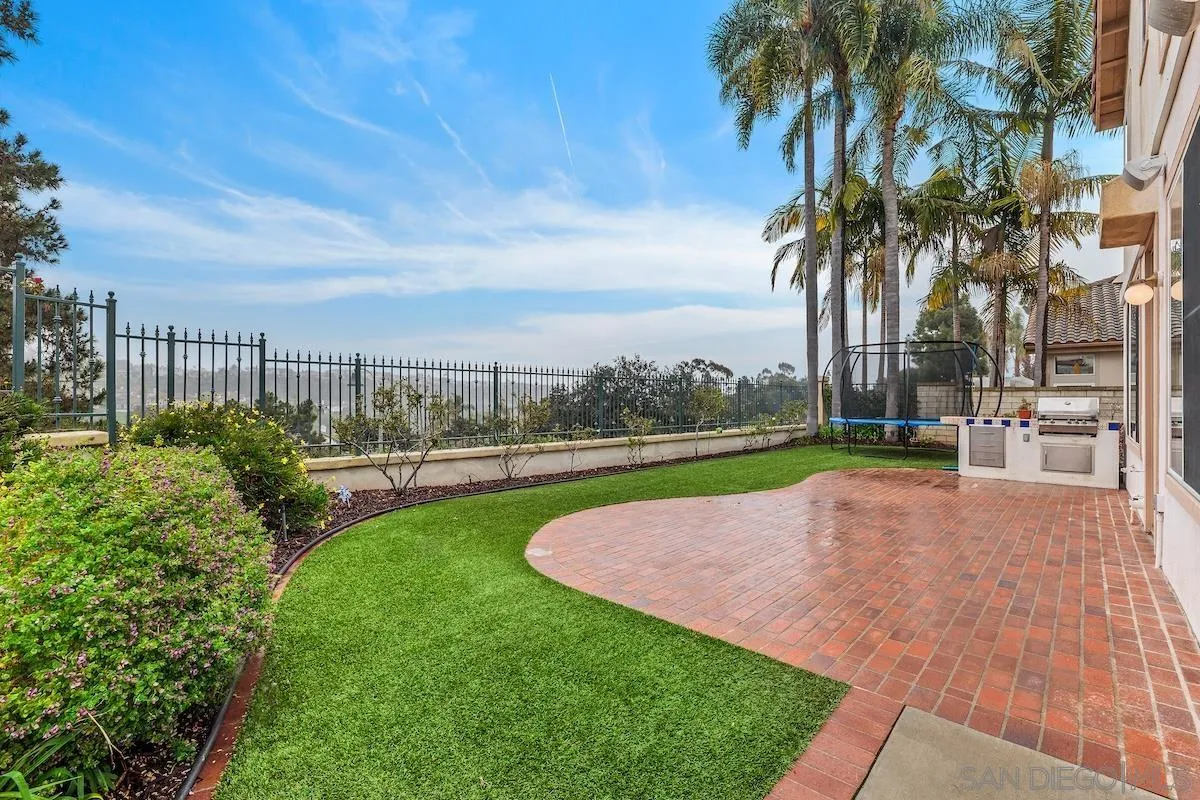 a view of yard with swimming pool and green space