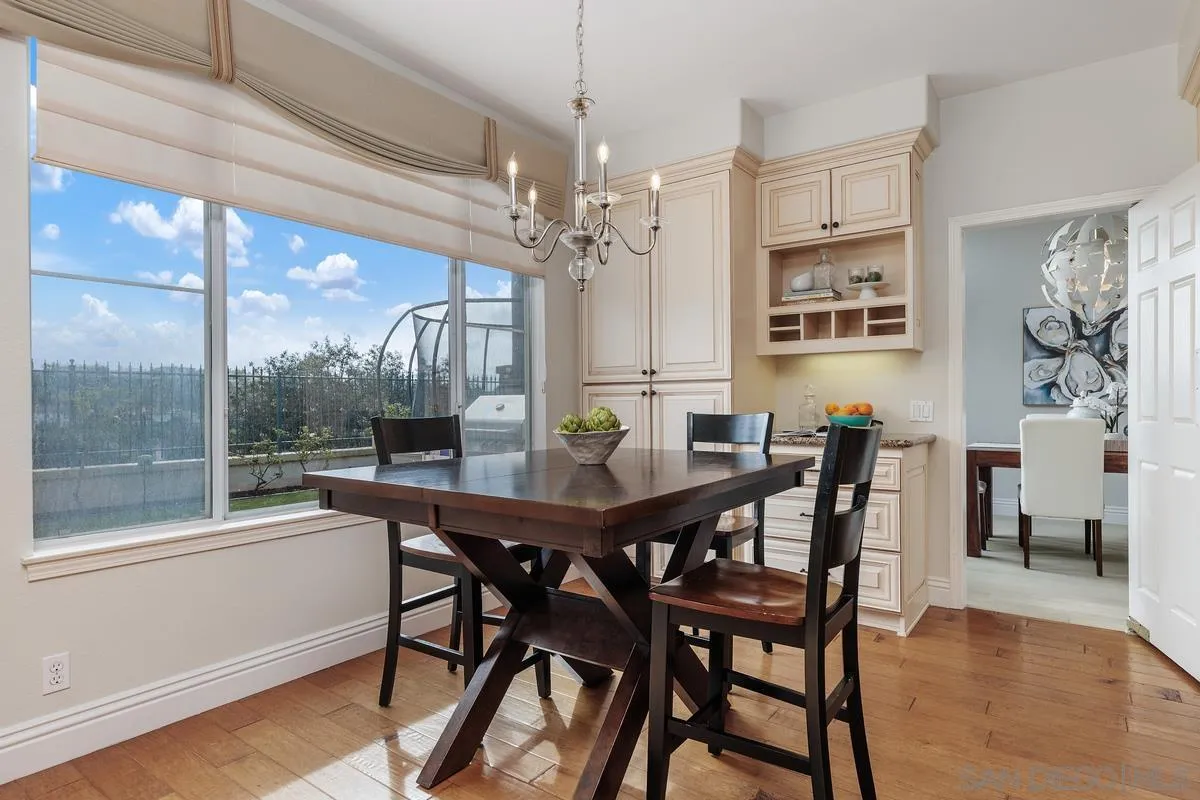 6943 Wildrose Terrace Carlsbad, CA 92011 - Photo 12 of 34 a view of a dining room with furniture window and wooden floor
