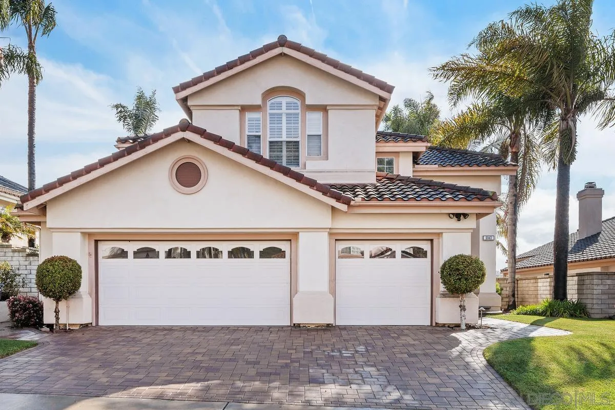 6943 Wildrose Terrace Carlsbad, CA 92011 - Photo 2 of 34 a front view of a house with garden