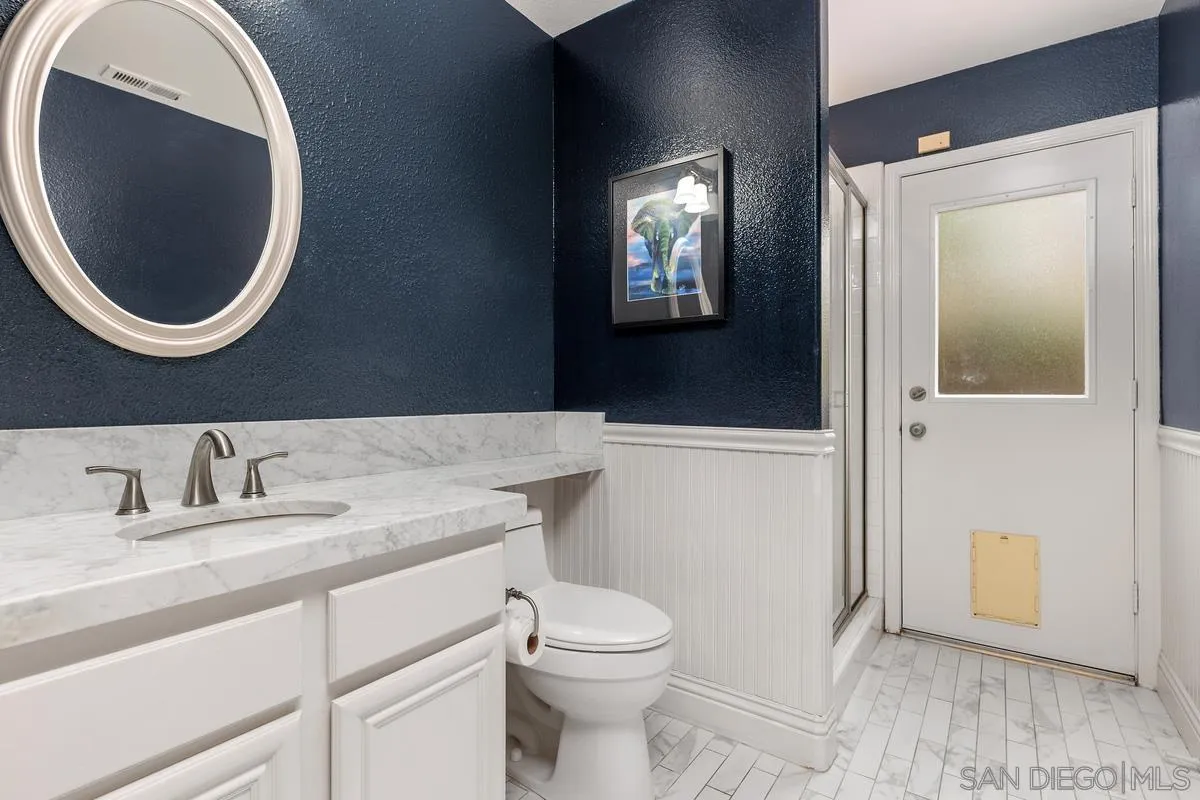 6943 Wildrose Terrace Carlsbad, CA 92011 - Photo 21 of 34 a bathroom with a toilet and a sink