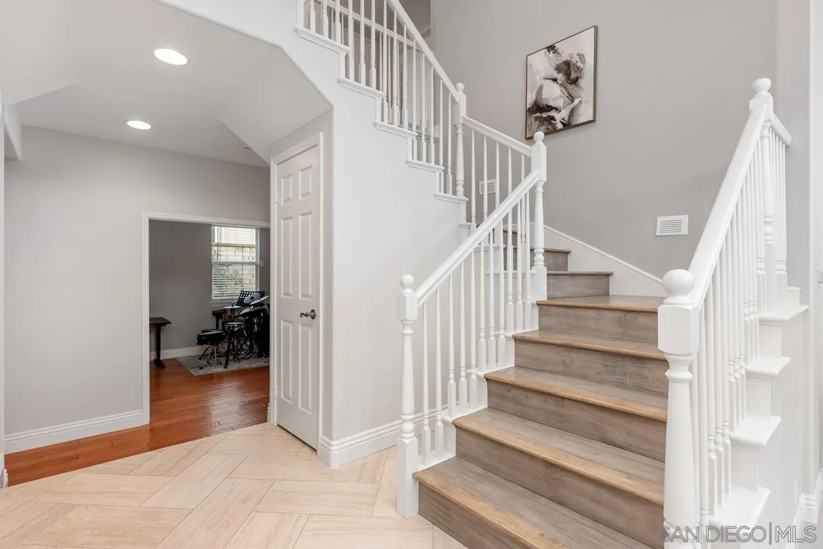 6943 Wildrose Terrace Carlsbad, CA 92011 - Photo 23 of 34 a view of entryway and hall with wooden floor