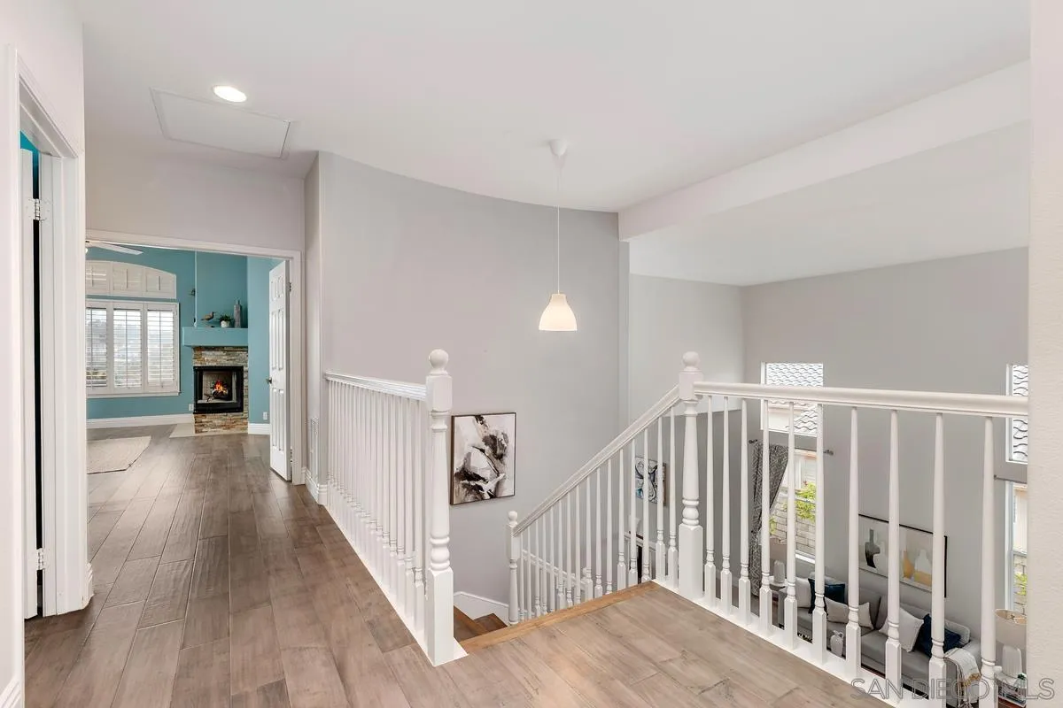 6943 Wildrose Terrace Carlsbad, CA 92011 - Photo 24 of 34 a view of a hallway with wooden floor and closet