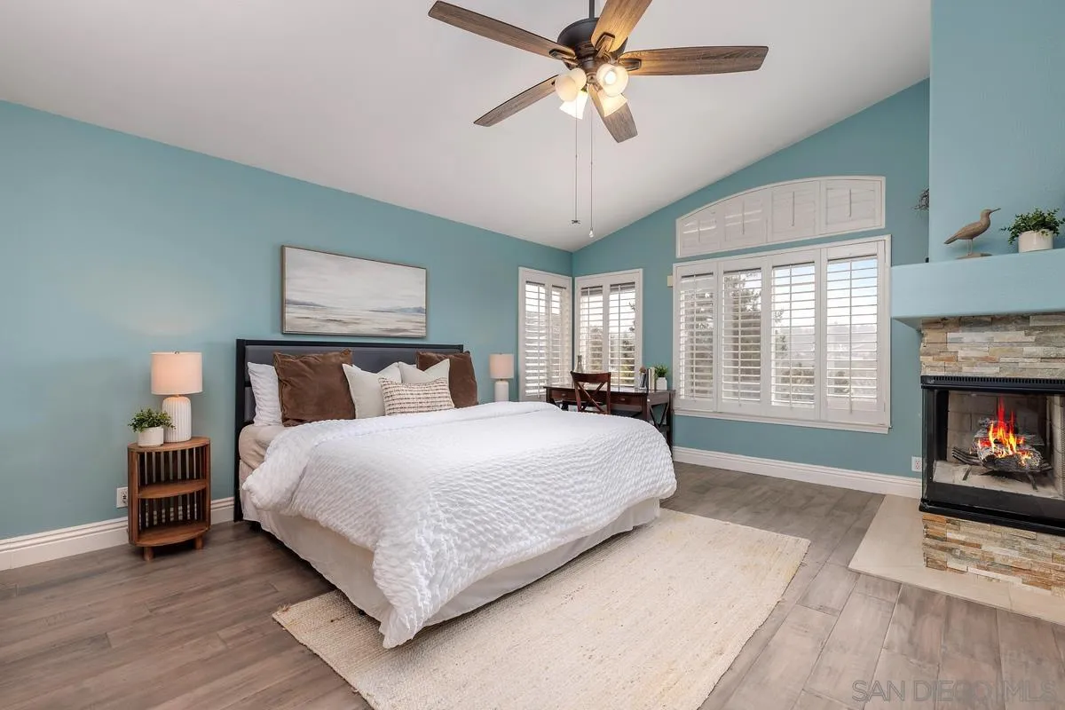 6943 Wildrose Terrace Carlsbad, CA 92011 - Photo 25 of 34 a bedroom with a bed and a fireplace