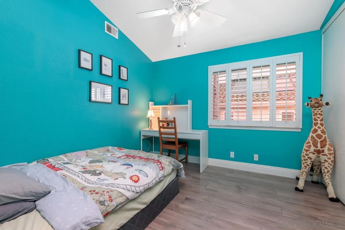 6943 Wildrose Terrace Carlsbad, CA 92011 - Photo 32 of 34 a bedroom with a bed and a window