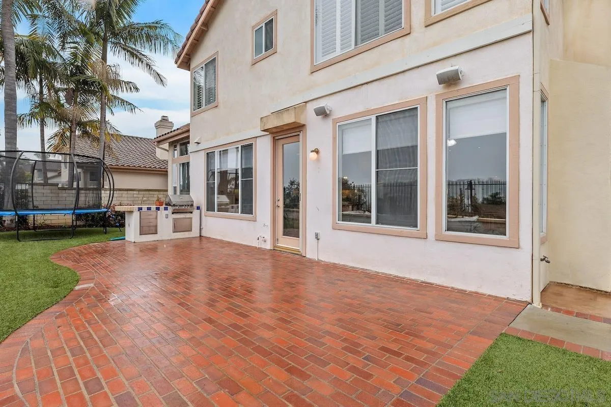 6943 Wildrose Terrace Carlsbad, CA 92011 - Photo 34 of 34 a view of a building with a garden