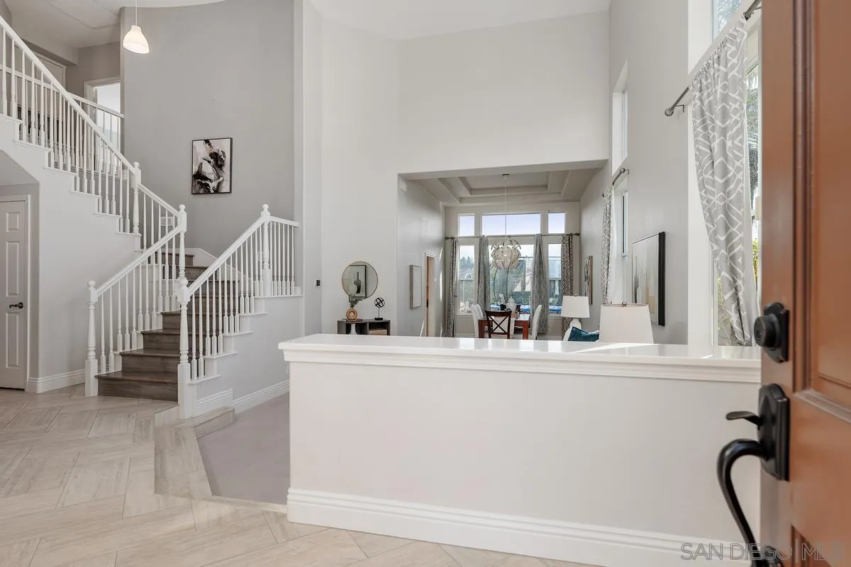 6943 Wildrose Terrace Carlsbad, CA 92011 - Photo 5 of 34 a living room with fireplace furniture and a large window