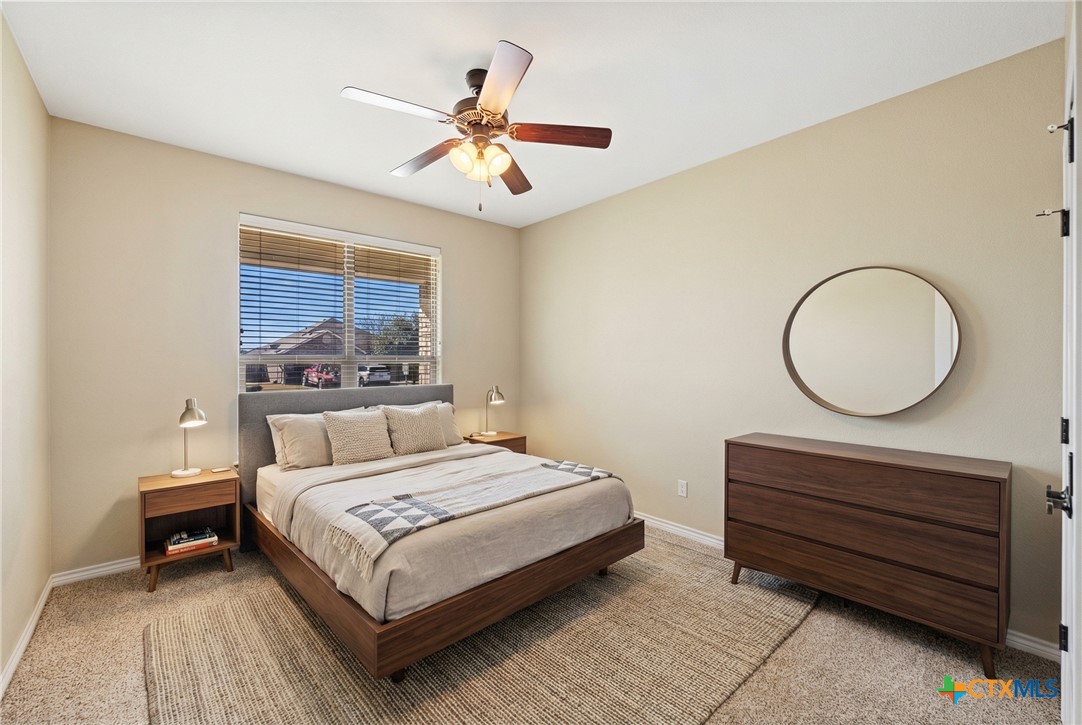 304 Jake Drive Jarrell, TX 76537 - Photo 14 of 30 a bedroom with a bed and a chandelier