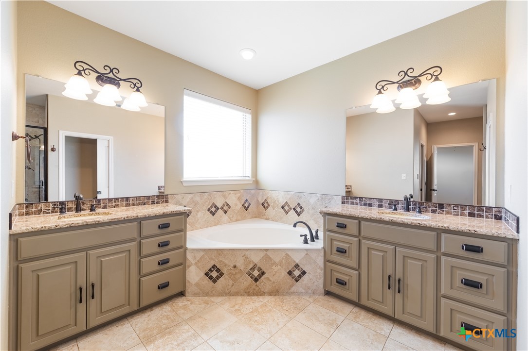 304 Jake Drive Jarrell, TX 76537 - Photo 20 of 30 a bathroom with a double vanity sink mirror and
