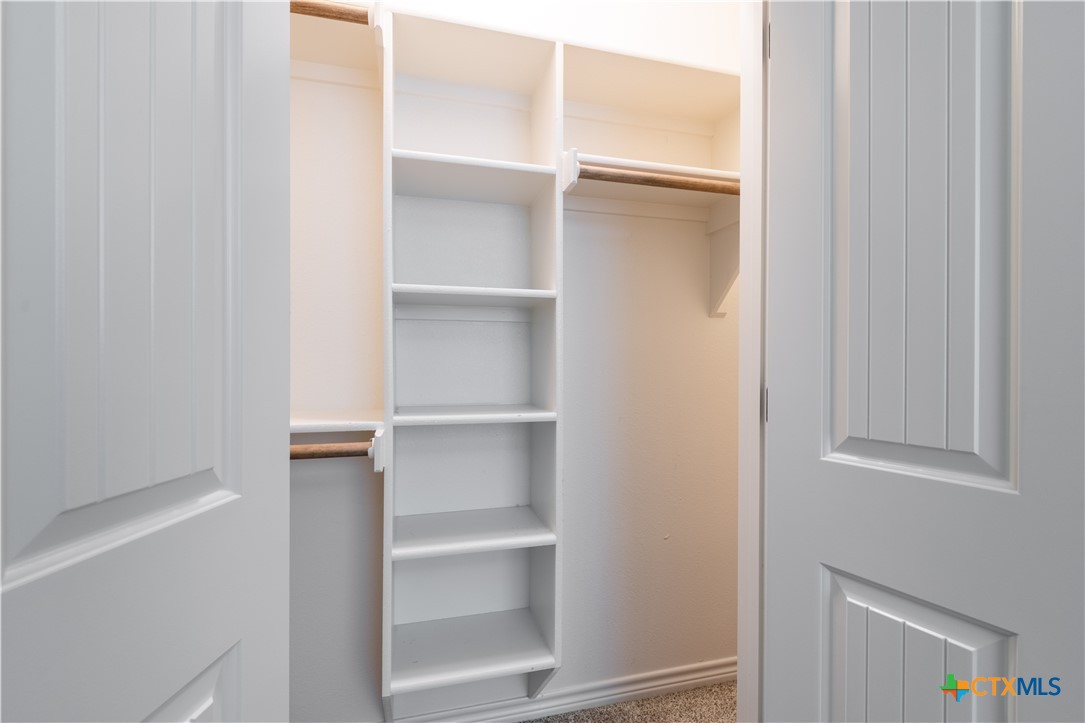 304 Jake Drive Jarrell, TX 76537 - Photo 22 of 30 a view of walk in closet with empty racks