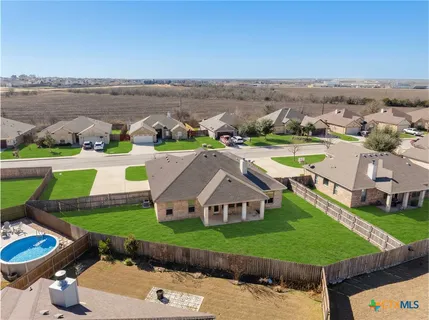 a view of a backyard with a garden and deck