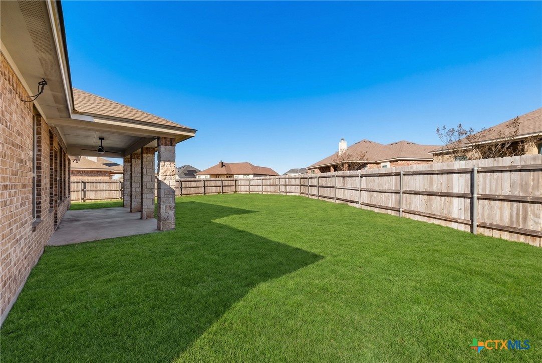 304 Jake Drive Jarrell, TX 76537 - Photo 28 of 30 a view of a backyard with a garden and deck