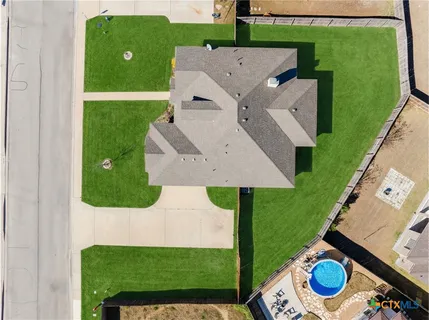 an aerial view of a house with a big yard