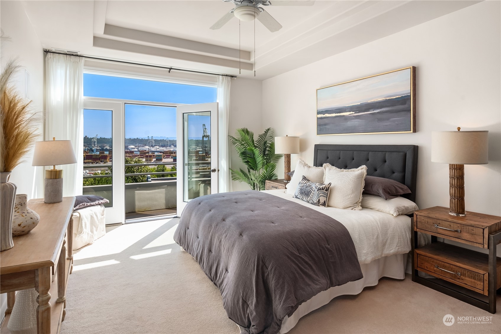 2349 Harbor Avenue Southwest, Unit 705 Seattle, WA 98126 - Photo 20 of 34 a spacious bedroom with a bed and a chandelier