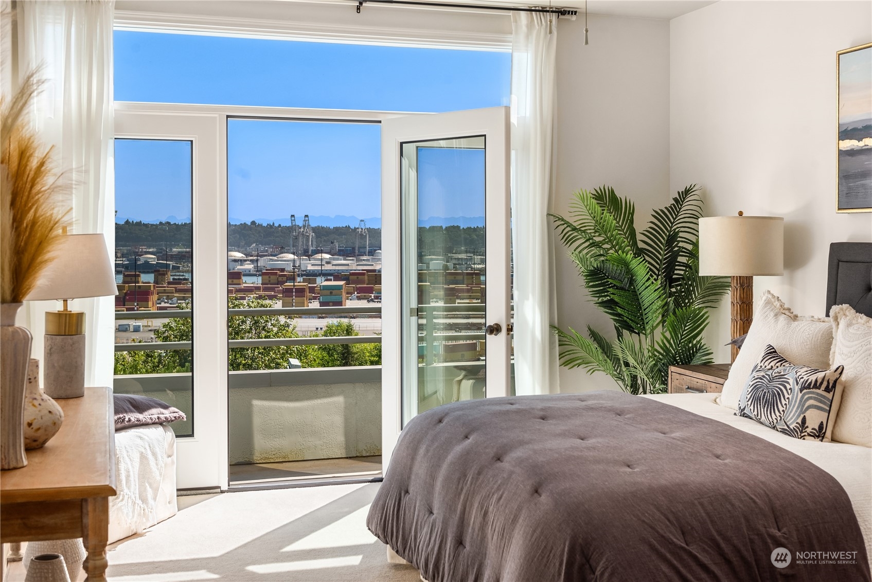 2349 Harbor Avenue Southwest, Unit 705 Seattle, WA 98126 - Photo 21 of 34 a bedroom with a bed and a potted plant