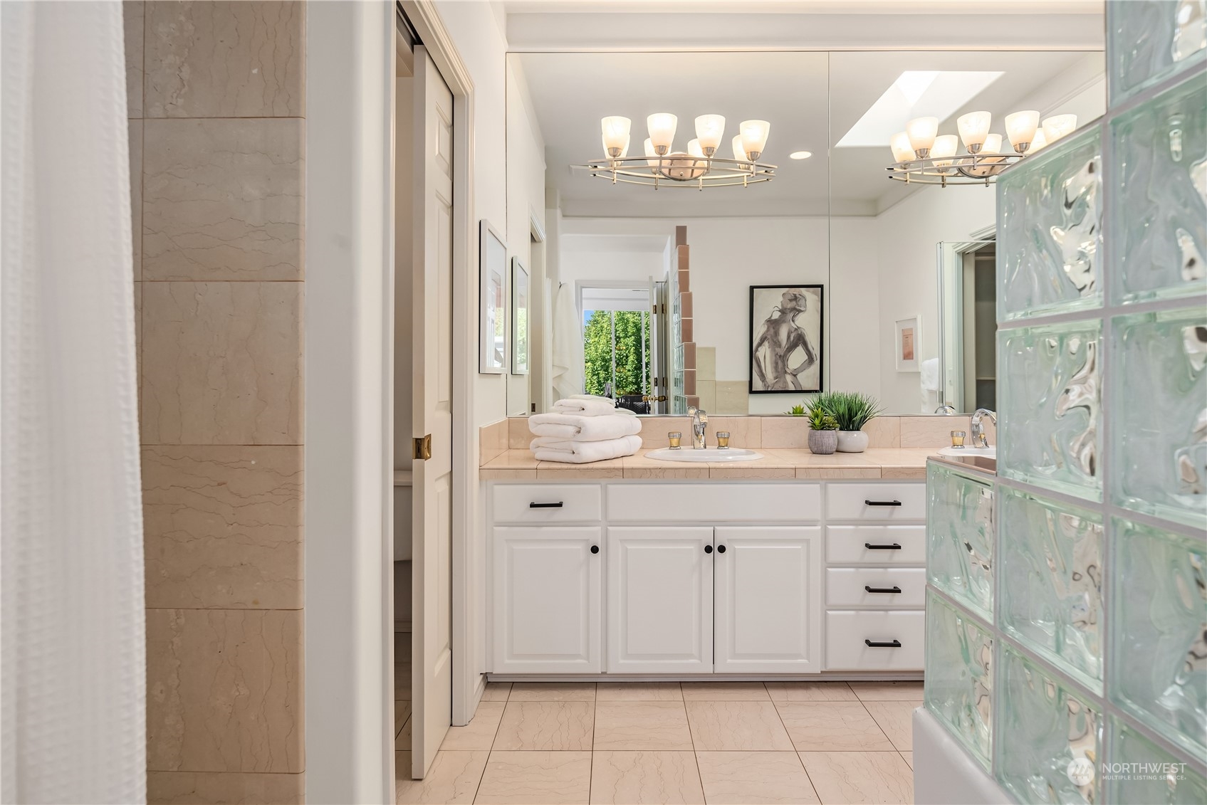 2349 Harbor Avenue Southwest, Unit 705 Seattle, WA 98126 - Photo 24 of 34 a spacious bathroom with a granite countertop sink a mirror and a