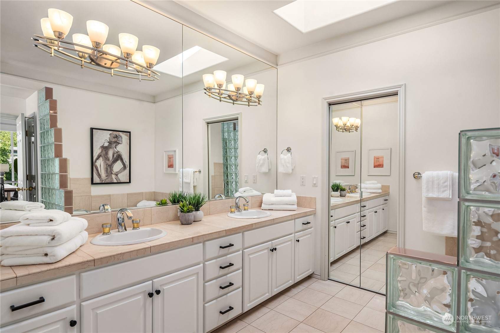 2349 Harbor Avenue Southwest, Unit 705 Seattle, WA 98126 - Photo 25 of 34 a spacious bathroom with double vanity a mirror a lamp a double vanity sink and a mirror