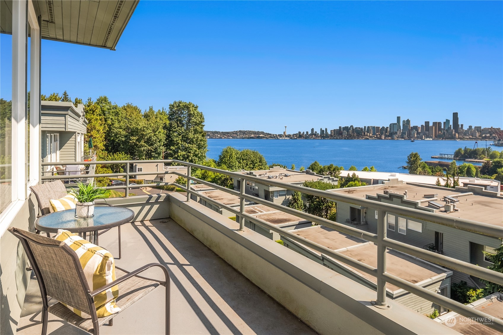 2349 Harbor Avenue Southwest, Unit 705 Seattle, WA 98126 - Photo 7 of 34 a view of a balcony with two chairs and a floor to ceiling window