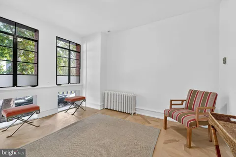 a bedroom with furniture and a window