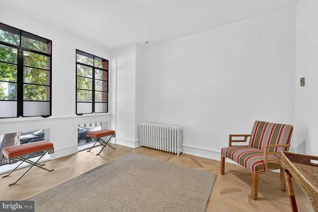 a bedroom with furniture and a window