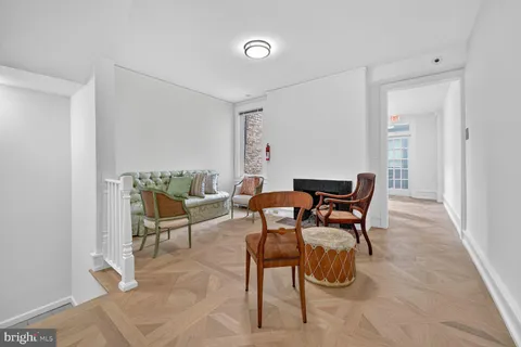 a dining room with furniture and a rug