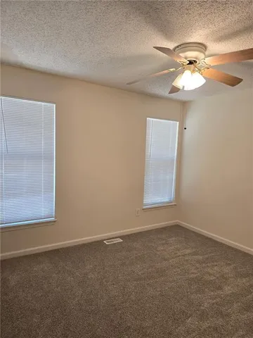 a view of a ceiling fan and a window