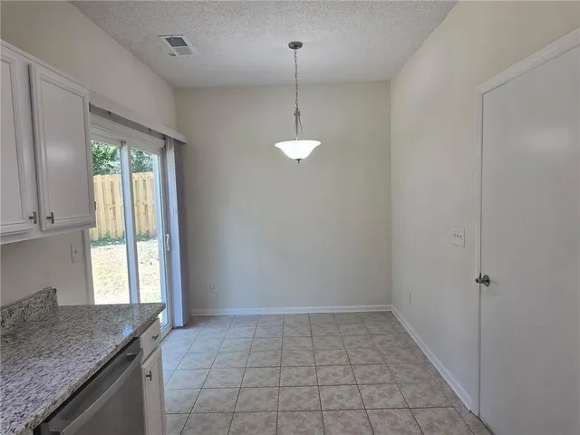 a kitchen with a granite countertop sink and window