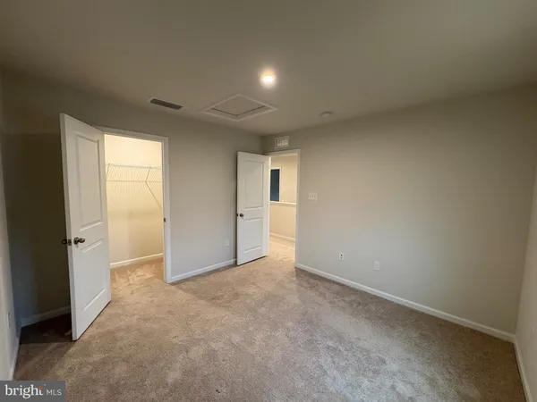 a view of an empty room and a window