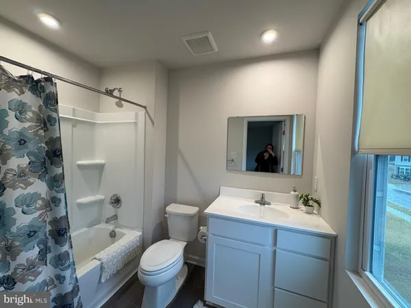 a bathroom with a sink toilet tub and shower