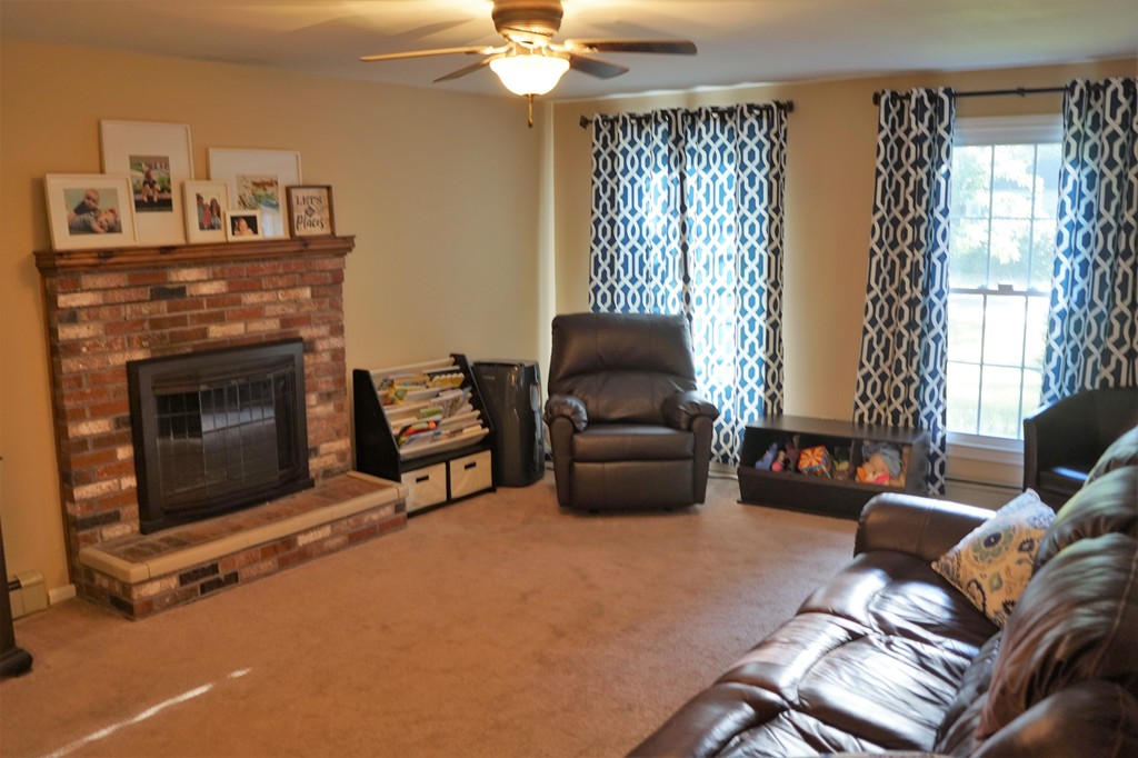 6 Pinewood Road Chelmsford, MA 01824 - Photo 11 of 27 a living room with furniture and a fireplace